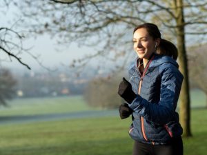 Woman keeping fit in winter by jogging